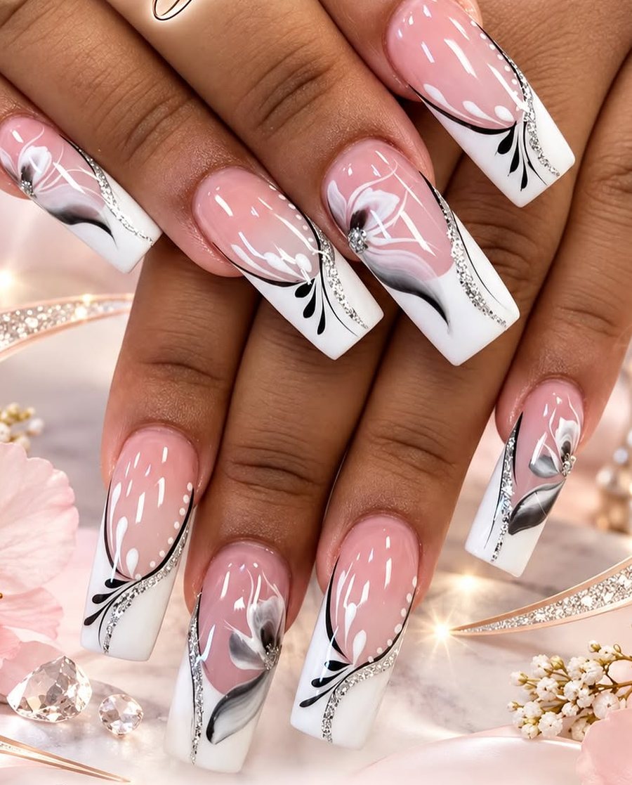 Pink and white French nails with hand-painted flowers, done at Magic Nails